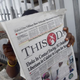 A man reads a newspaper with a headline on July 27, 2014, announcing government efforts in Lagos, Nigeria, to screen for Ebola.
PIUS UTOMI EKPEI/AFP/Getty Images